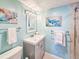 Charming bathroom with nautical decor, tiled shower, and modern vanity at 3606 S Peninsula Dr # 703, Port Orange, FL 32127