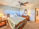Comfortable bedroom featuring a ceiling fan, wood furniture and nautical themed decor at 3606 S Peninsula Dr # 703, Port Orange, FL 32127