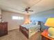 The bedroom features a ceiling fan, a window, and carpet at 3606 S Peninsula Dr # 703, Port Orange, FL 32127