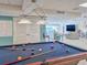 Billiard table in the common game room area with a lounge and waterfront views at 3606 S Peninsula Dr # 703, Port Orange, FL 32127