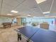 Spacious game room area featuring a ping pong table, billiard table, lounge area, and waterfront views at 3606 S Peninsula Dr # 703, Port Orange, FL 32127