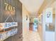 Inviting hallway with tiled floor, unit number, and decor leading to the living area at 3606 S Peninsula Dr # 703, Port Orange, FL 32127