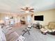 Open floor plan living room and dining area with plush carpet at 3606 S Peninsula Dr # 703, Port Orange, FL 32127