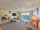 Inviting living room with ceiling fan, balcony access, and comfortable seating at 3606 S Peninsula Dr # 703, Port Orange, FL 32127