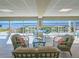 Bright lounge area featuring stylish seating and stunning waterfront views through large windows at 3606 S Peninsula Dr # 703, Port Orange, FL 32127
