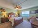 Well-lit main bedroom boasts a waterfront view, ceiling fan, and ample closet space at 3606 S Peninsula Dr # 703, Port Orange, FL 32127