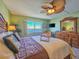 The main bedroom boasts waterfront view, ceiling fan, and beach themed decor at 3606 S Peninsula Dr # 703, Port Orange, FL 32127
