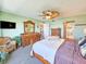 The main bedroom boasts ceiling fan, beach themed decor, and en suite bathroom at 3606 S Peninsula Dr # 703, Port Orange, FL 32127