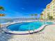 Community pool and surrounding deck with views of the bay and bridge at 3606 S Peninsula Dr # 703, Port Orange, FL 32127
