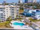 Aerial shot of a kidney bean shaped pool and condo building near a neighborhood at 3606 S Peninsula Dr # 703, Port Orange, FL 32127
