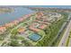 Community aerial featuring pools, tennis courts, and easy access to the beach, and waterway views at 402 Bouchelle Dr # 206, New Smyrna Beach, FL 32169
