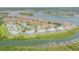Aerial view of a waterfront community with lush landscaping and boat docks, near the ocean at 402 Bouchelle Dr # 206, New Smyrna Beach, FL 32169