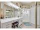 Modern bathroom featuring double sinks, vanity, a glass-enclosed shower, and decorative accents at 402 Bouchelle Dr # 206, New Smyrna Beach, FL 32169