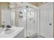 Bright bathroom featuring a tiled shower with glass doors and a modern sink at 402 Bouchelle Dr # 206, New Smyrna Beach, FL 32169