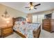 Well-lit bedroom with a wooden bed frame, matching nightstands, and a dresser, creating a coastal ambiance at 402 Bouchelle Dr # 206, New Smyrna Beach, FL 32169