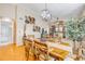 Open-concept living space with dining table, decorative wall hangings, and a glimpse of a bathroom at 402 Bouchelle Dr # 206, New Smyrna Beach, FL 32169