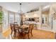 Dining area featuring a wooden table, chairs, and view into a kitchen area with counter seating at 402 Bouchelle Dr # 206, New Smyrna Beach, FL 32169