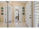 Welcoming entryway with mirrored closet and coastal decor accents at 402 Bouchelle Dr # 206, New Smyrna Beach, FL 32169