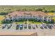 Well maintained condo building featuring a red tile roof, balconies, and parking area at 402 Bouchelle Dr # 206, New Smyrna Beach, FL 32169