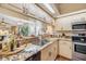 Modern kitchen featuring granite countertops, stainless steel appliances, and a view to the living room at 402 Bouchelle Dr # 206, New Smyrna Beach, FL 32169