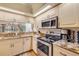 Well-equipped kitchen featuring stainless steel appliances and granite countertops with lots of light at 402 Bouchelle Dr # 206, New Smyrna Beach, FL 32169