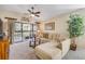Comfortable living room featuring a sectional sofa, glass coffee table, and sliding glass doors to a patio at 402 Bouchelle Dr # 206, New Smyrna Beach, FL 32169