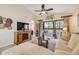 Bright living room with vaulted ceiling, decorative fireplace, and sliding door to a balcony at 402 Bouchelle Dr # 206, New Smyrna Beach, FL 32169