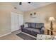 Comfortable living room featuring a gray sofa and coastal-themed decor at 402 Bouchelle Dr # 206, New Smyrna Beach, FL 32169