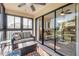 Enclosed patio with cozy seating, offering a glimpse of the living room through sliding glass doors at 402 Bouchelle Dr # 206, New Smyrna Beach, FL 32169
