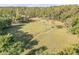 Aerial view of a sprawling property with large grassy fields surrounded by dense forest at 416 Western Rd, New Smyrna Beach, FL 32168