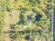 Stunning aerial view of property with serene pond, lush landscaping and mature trees at 416 Western Rd, New Smyrna Beach, FL 32168