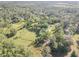 Expansive aerial view showcasing lush greenery, mature trees, and the property's peaceful setting at 416 Western Rd, New Smyrna Beach, FL 32168