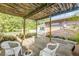 Back patio featuring a rustic wood pergola, outdoor seating, and garden containers create a cozy outdoor space at 416 Western Rd, New Smyrna Beach, FL 32168