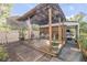 Back patio featuring a rustic wood pergola, concrete patio, outdoor seating, and garden containers create a cozy space at 416 Western Rd, New Smyrna Beach, FL 32168