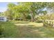 Expansive backyard featuring mature trees and lush green grass, perfect for outdoor activities and relaxation at 416 Western Rd, New Smyrna Beach, FL 32168