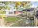 View of landscaped backyard with potting area, shed, and outdoor seating, enclosed by a picket fence at 416 Western Rd, New Smyrna Beach, FL 32168