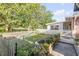 Charming backyard with a white picket fence and lush greenery, perfect for gardening at 416 Western Rd, New Smyrna Beach, FL 32168
