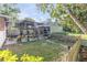 Spacious backyard with a covered patio area, planters, and grass at 416 Western Rd, New Smyrna Beach, FL 32168