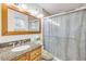 Bathroom featuring a granite-topped vanity and glass-enclosed shower at 416 Western Rd, New Smyrna Beach, FL 32168