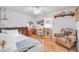 Bright bedroom with hardwood flooring, charming decor, and a cozy reading nook at 416 Western Rd, New Smyrna Beach, FL 32168