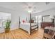 Bedroom featuring wood floors, a four-poster bed, and a white ceiling fan at 416 Western Rd, New Smyrna Beach, FL 32168