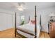 Charming bedroom offers white bedding, wood floors and natural light at 416 Western Rd, New Smyrna Beach, FL 32168