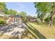 Charming single-story brick home with a well-maintained lawn and mature trees at 416 Western Rd, New Smyrna Beach, FL 32168