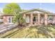 Inviting brick home featuring a covered front porch and lush landscaping at 416 Western Rd, New Smyrna Beach, FL 32168