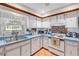 Charming kitchen featuring white cabinets, blue countertops, and stainless steel appliances at 416 Western Rd, New Smyrna Beach, FL 32168