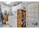 Well-organized laundry room with washer, dryer, and custom shelving for storage at 416 Western Rd, New Smyrna Beach, FL 32168