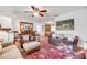 Inviting living room with a ceiling fan, hardwood floors, comfortable seating, and views into the dining area at 416 Western Rd, New Smyrna Beach, FL 32168