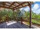 Wooden deck and railing with views of tropical landscaping and neighborhood at 4262 Cardinal Blvd, Port Orange, FL 32127