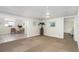 Open basement area with checkered carpet transitioning into tiled flooring, showcasing a casual seating area at 4262 Cardinal Blvd, Port Orange, FL 32127