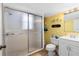 Well-lit bathroom with a white vanity, glass shower and yellow walls at 4262 Cardinal Blvd, Port Orange, FL 32127